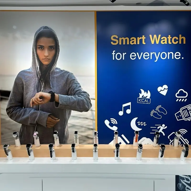 Row of smart watch security display stands in front of a Smart Watch for everyone campaign graphic
